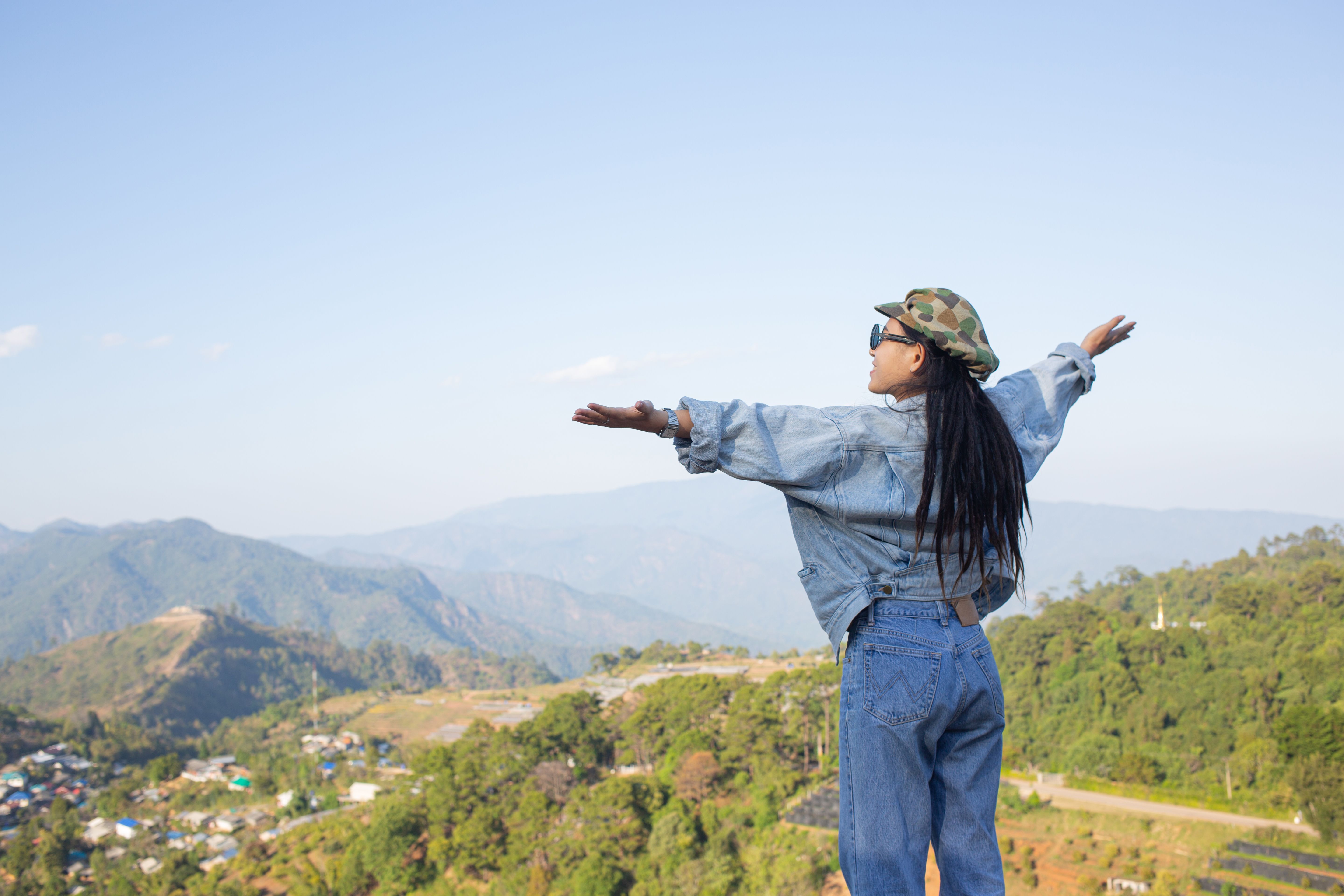 woman-spread-arms-middle-high-trees-nature-forest.jpg